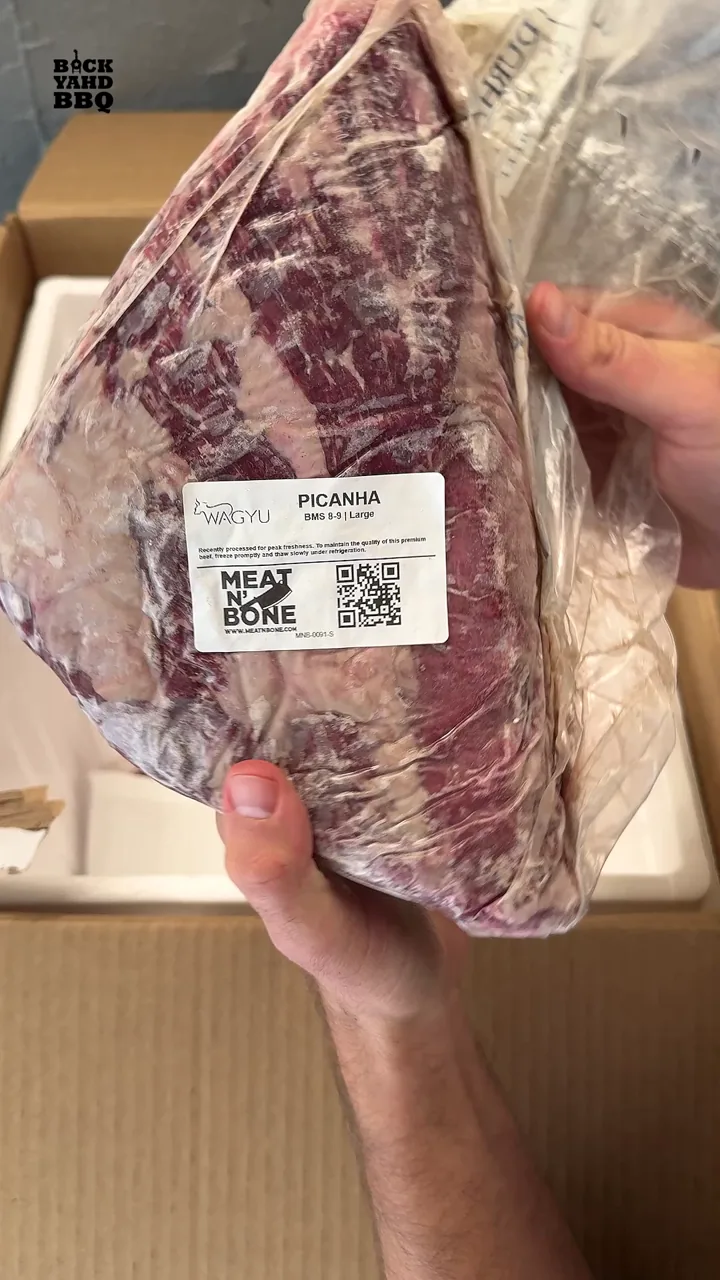 Vacuum sealed picanha held above the Meat N’ Bone box