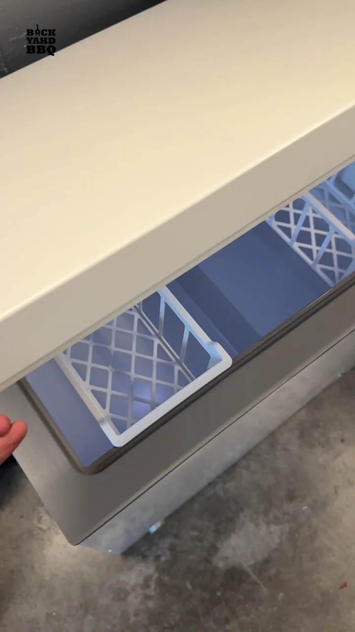 Open Midea chest freezer with a removable basket