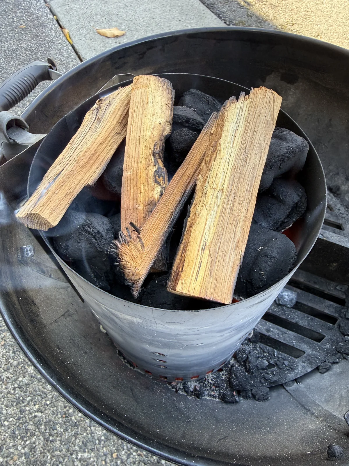 Charcoal chimney set inside the kettle before the sear