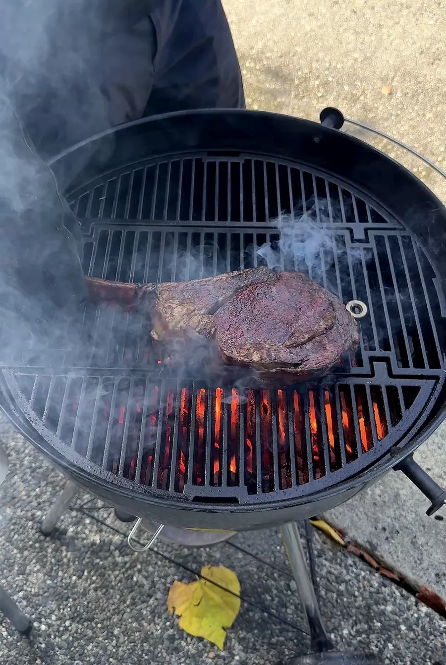 Seared Wagyu tomahawk over glowing coals on the Weber kettle